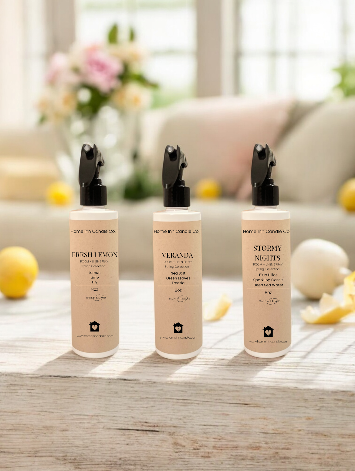Three bottles of room sprays labeled Fresh Lemon, Veranda and Stormy Nights from Home Inn Candle Co Spring Room Spray collection with spring decor