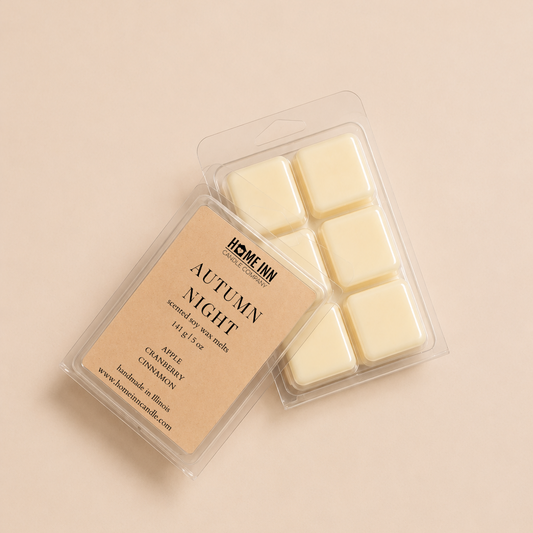 A wax melt package labeled 'Autumn Night' by Home Inn Candle, showing six off-white wax cubes in a clear plastic clamshell with a beige label, photographed on a warm beige background.