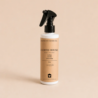 A  room spray bottle of coffee house from Home Inn Candle with a beige label and black trigger sprayer, set against a solid beige background.
