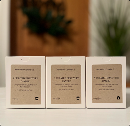 Three Home Inn Candle Co. candle boxes on a neutral background