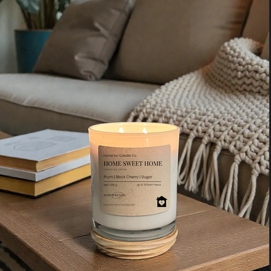 Candle labeled 'Home Sweet Home' on a coffee table in a cozy living room.