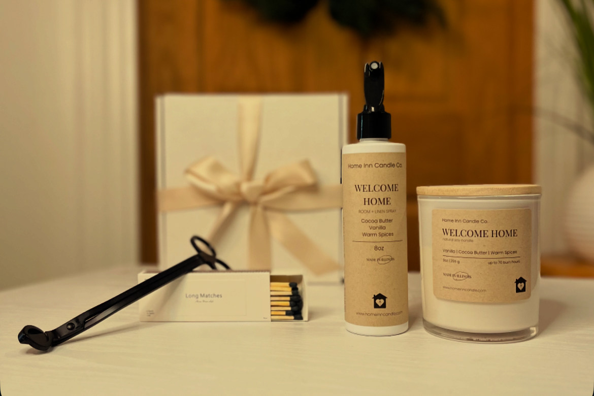 Home fragrance items including a room spray, candle, and box on a surface with a warm-toned background as part of the housewarming gift from Home Inn Candle