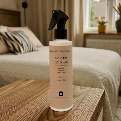 Room Spray Bottle labeled Master Bedroom by Home Inn Candle in a bedroom with home decor
