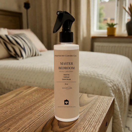 Room Spray Bottle labeled Master Bedroom by Home Inn Candle in a bedroom with home decor