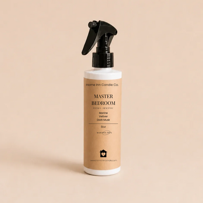 A bottle of Master Bedroom room spray from Home Inn Candle with a black trigger sprayer and a beige label, set against a solid beige background.