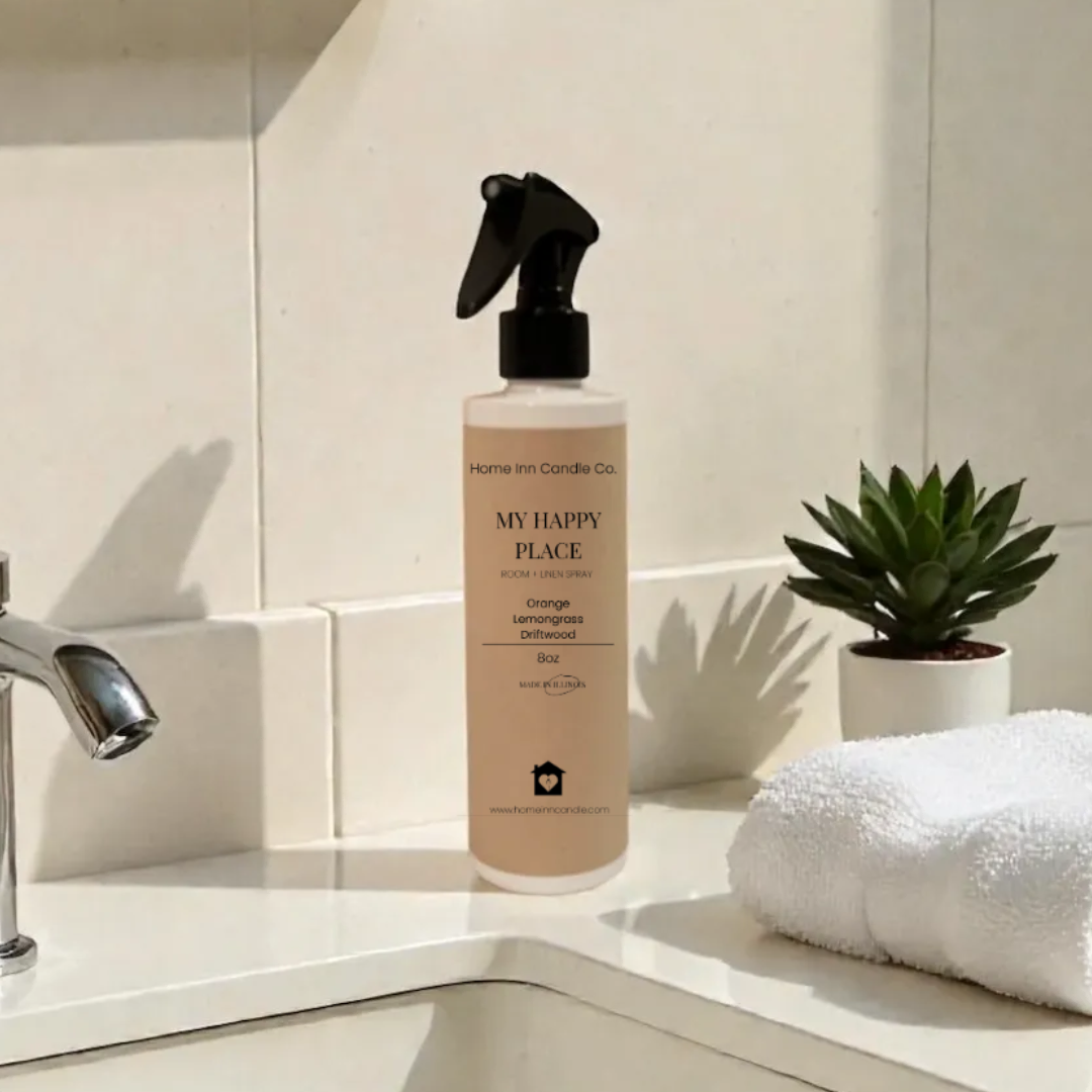 My Happy Place Room Spray from Home Inn Candle on a bathroom counter with sink and towel in the background