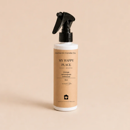 A bottle of My Happy Place Room spray from Home Inn Candle with a black trigger sprayer and a beige label, set against a solid beige background.