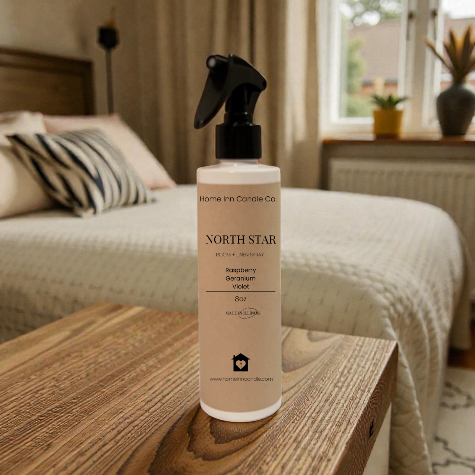 Bottle of Home Inn Candle 'North Star' room spray on a wooden surface with a bedroom in the background