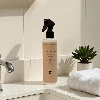 Home Inn Candle North Star Room Spray in bathroom with sink and towel with home decor