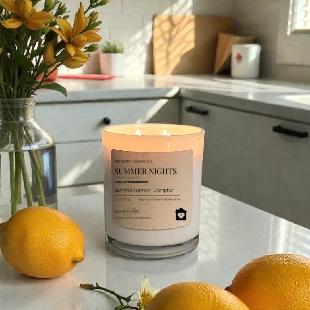 Candle with flowers and lemons on a kitchen counter. Home Inn Candle Summer Nights Candle
