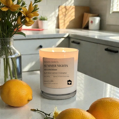 Candle with flowers and lemons on a kitchen counter. Home Inn Candle Summer Nights Candle