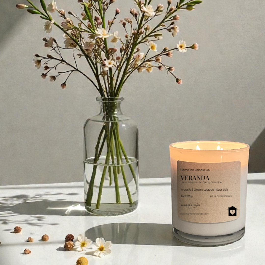 Veranda Candle from Home Inn Candle on white table with flowers