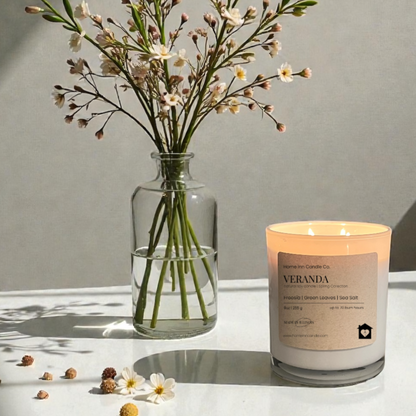 Veranda Candle from Home Inn Candle on white table with flowers