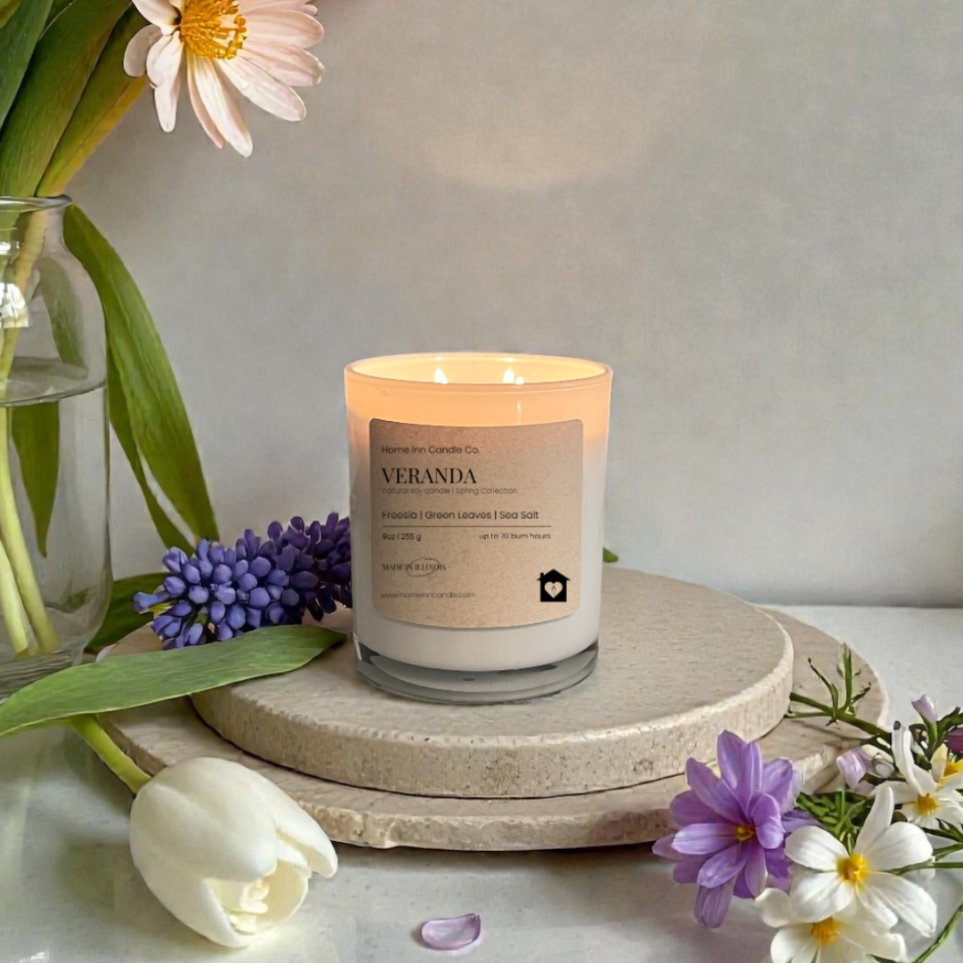 Veranda Candle from Home Inn Candle with lily flowers on a wood home decor white table