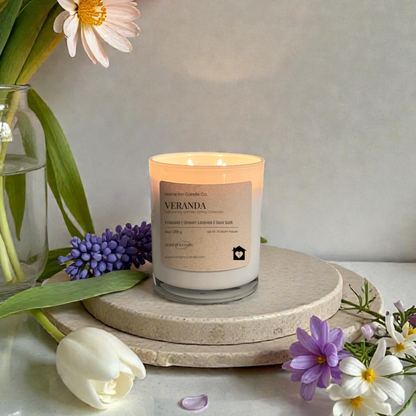 Veranda Candle from Home Inn Candle with lily flowers on a wood home decor white table