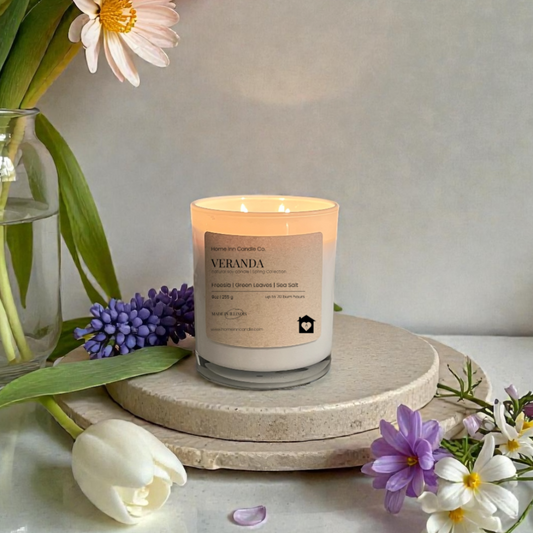 Veranda Candle from Home Inn Candle with lily flowers on a wood home decor white table