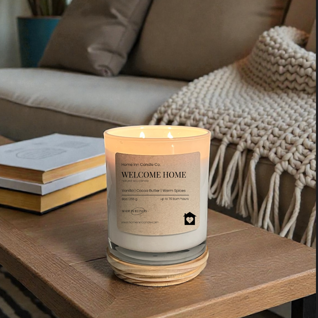 Candle labeled 'Welcome Home' on a coffee table in a cozy living room.